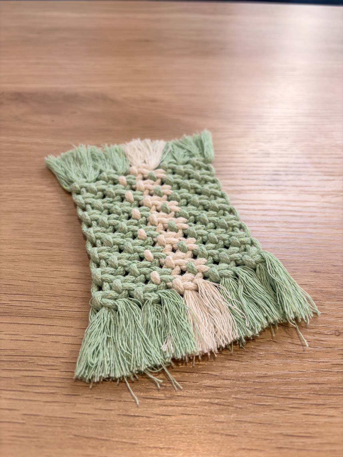Handmade macrame wall hanging in sage green and cream